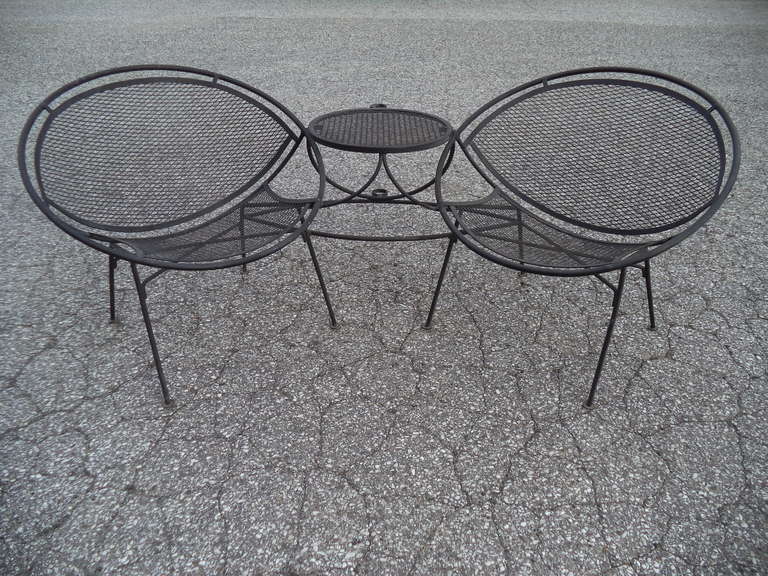 Rare 1950's Maurizio Tempestrini for Salterini Clamshell Tete a Tete.
Newly refinished and ready for your patio of rooftop terrace.
Just insert umbrella in the holder on the rear of the connecting tabletop.