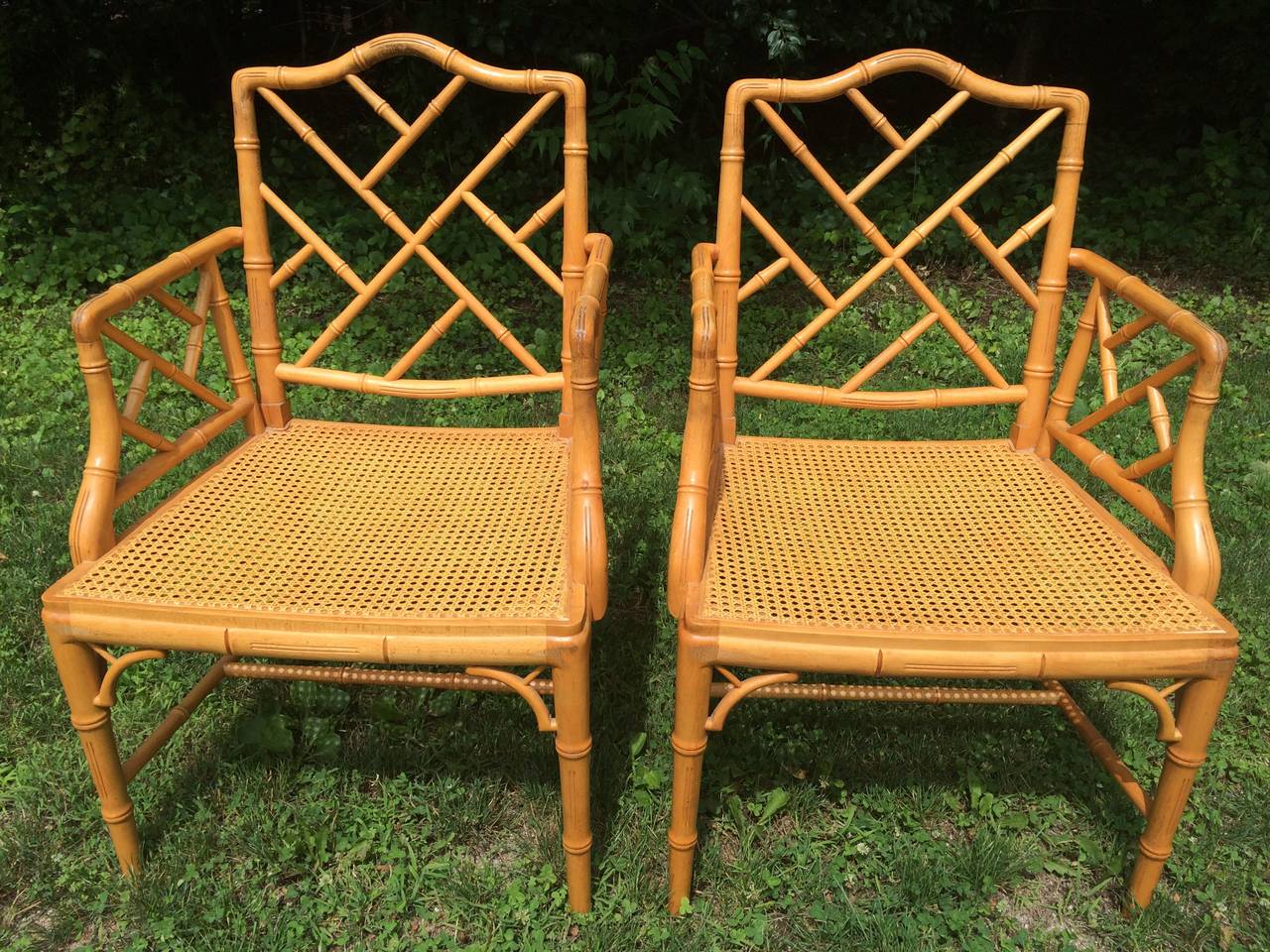 Pair of Chinese Chippendale Bamboo Chairs. These chairs have perfect condition caned seats but also come with custom fitted cushions.