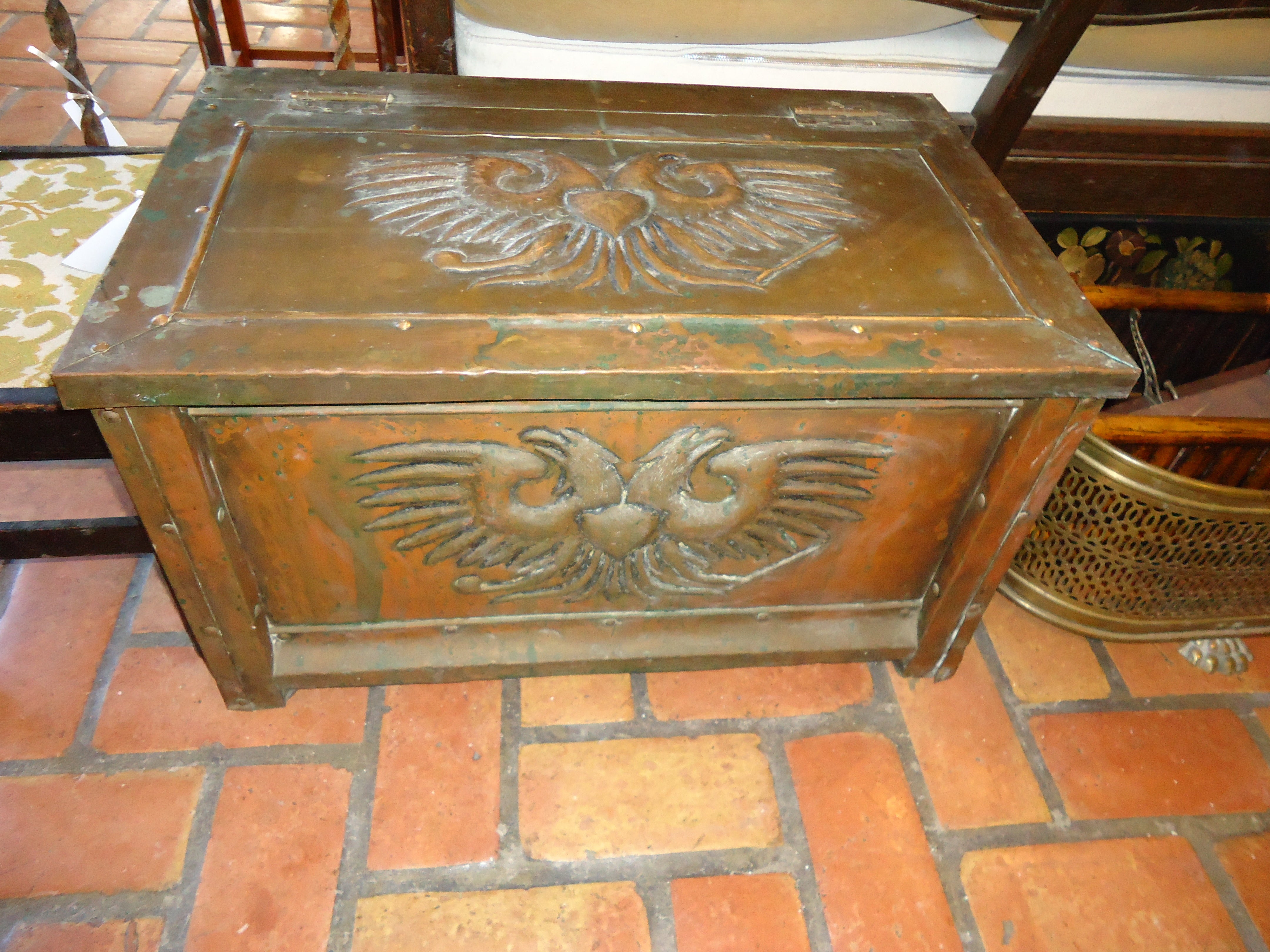 Finely embossed antique brass firewood box with wonderful patina. Nice hinged lid and castors on the base for easy moving. Inside is lined with wood and clean. This can be parcel shipped at a very reasonable  rate please request a rate. 