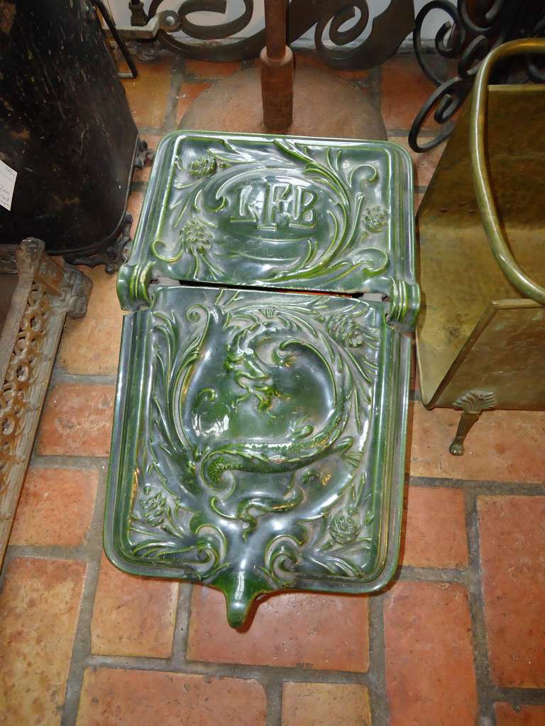 This exquisitely detailed coal scuttle is an exceptional piece of art as well as a functional holder for coal or kindling . It can also be used to place used fireplace ashes in or fire starters . The base is a heavy cast Iron and the top is a heavy