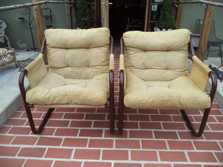 Danish Sling Chairs. Fabric is a thick weaved burlap- like linen. Metal is tubular and dark brown in color.