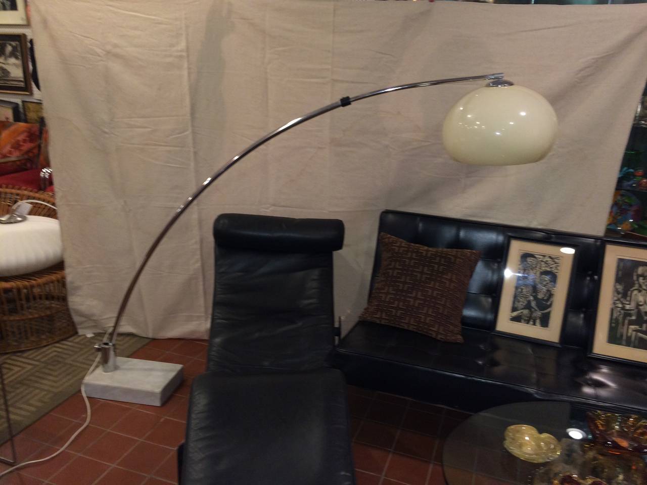 
 Mid-Century Arc Floor Lamp in Chrome with white Marble Base. There are two settings on this lamp which are controlled by the chrome turn handle on the side. The setting with the lamp stem all the way to the left is 56