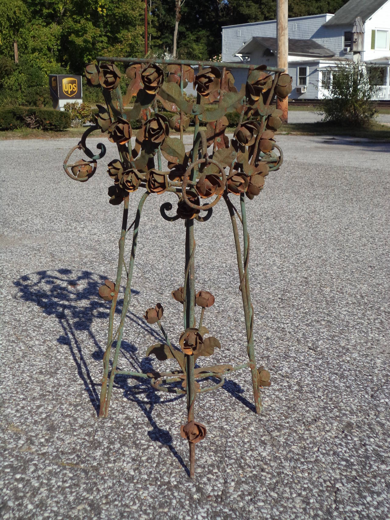 Antique Iron Floral Planter Stand. Cascading rosettes adorn this one of a kind piece.