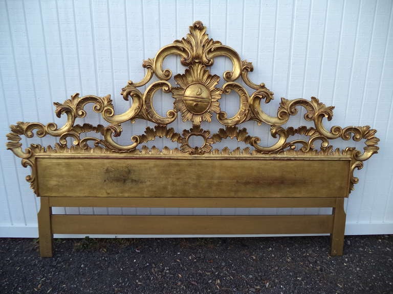This heavily carved gold gilt headboard is in excellent condition and will make a magnificent statement in any bedroom. Hand carved and gilded in Florence Italy.This item can be wall mounted to be the correct height for any bed .
