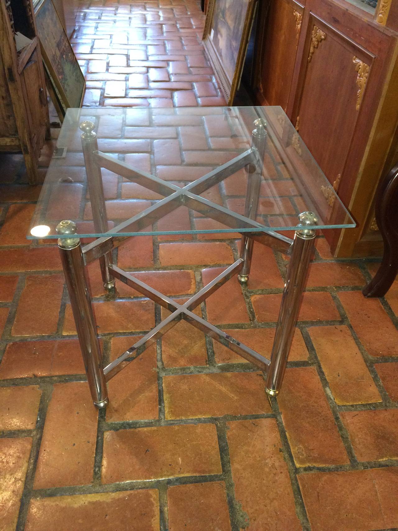 Chrome and glass side table in the manner of Maison Jansen. Glass is removable for easy shipping.