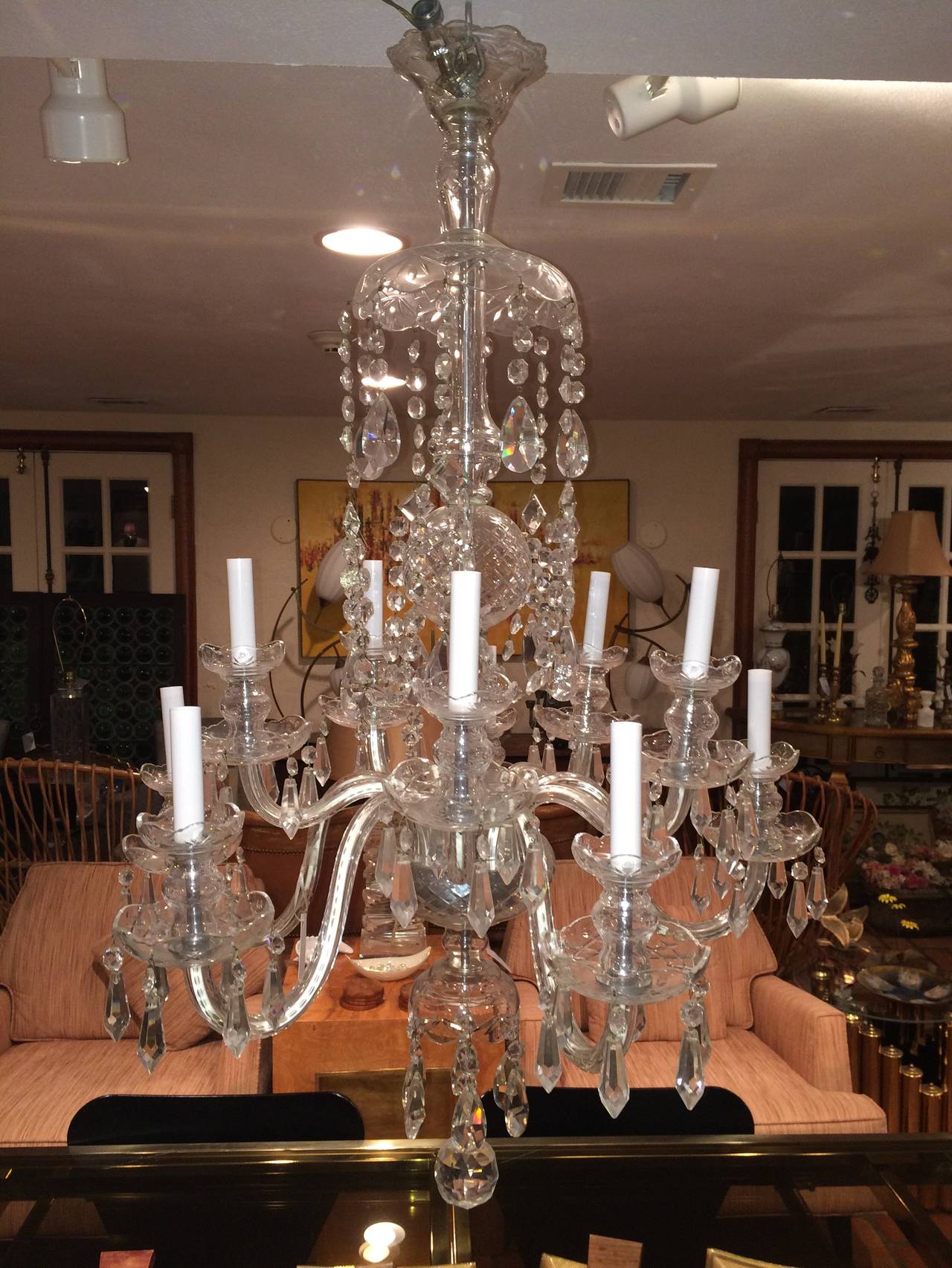 Elegant Ten Arm Crystal Chandelier attributed to Waterford. Draped with flowing crystals pendants and a faceted crystal ball pendant.