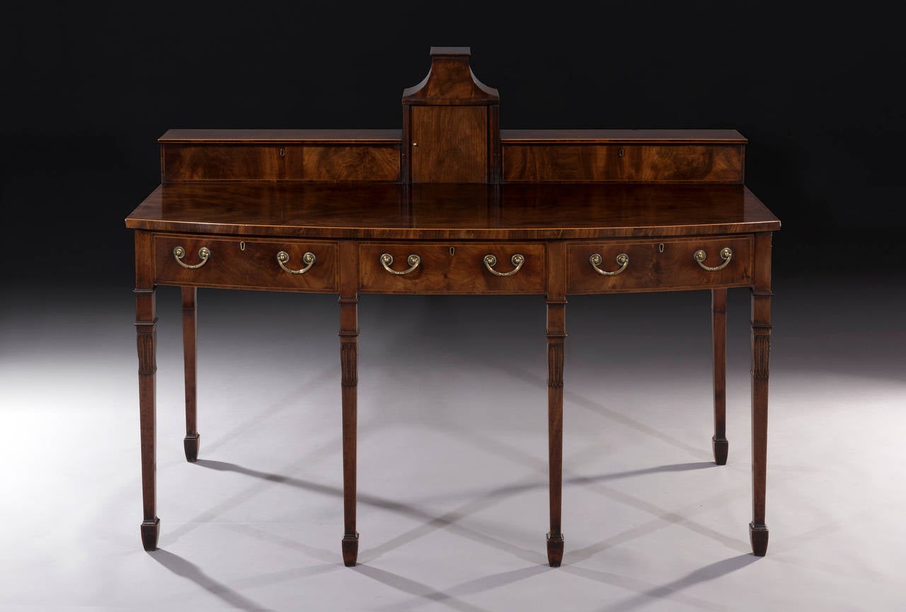 This rare serving table is in great original condition. An unusual pagoda structure is flanked by cellarette cupboards which carry the original divisions and magnum sized bottles could fit into it! 

The beautiful figured mahogany top with