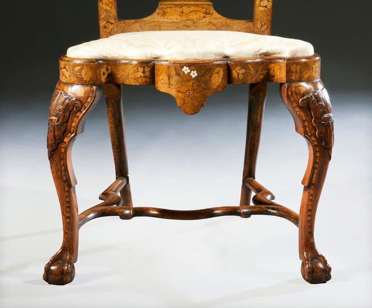 'The Dunecht House Chairs' - An exquisite Pair of Dutch Ivory & Fruitwood Marquetry inlaid Walnut Side Chairs 

Each with a foliate rocaille carved top-rail above vase-shaped splats, the beautifully shaped seat rails, with drop-in seats, are