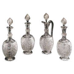 Set of Three Cut Glass Decanters with a Claret Jug