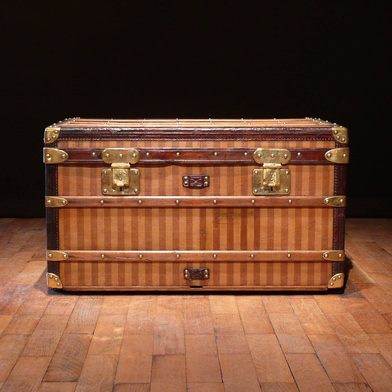 A rare Louis Vuitton striped canvas trunk with leather trim, brass fittings and interior base re-lined. Circa 1885. 

Dimensions: 80 cm (length) x 47 cm (depth) x 46 cm (height).

Member of LAPADA.