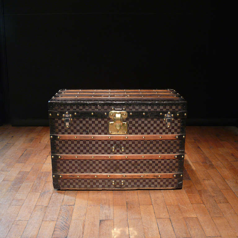 A fine Damier pattern steel bound Louis Vuitton steamer trunk with blackened steel trim and handles. The interior has been relined in the style of the original. Circa 1895.

Dimensions: 76 cm (width) x 43 cm (depth) x 54.5 cm (height).