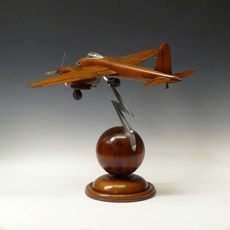 A splendid wooden model of a De Havilland Mosquito with retracting landing gear and moveable ailerons and tail plane. On Art Deco style base. Circa 1945.

Dimensions: 38 cm x 51 cm x 41 cm