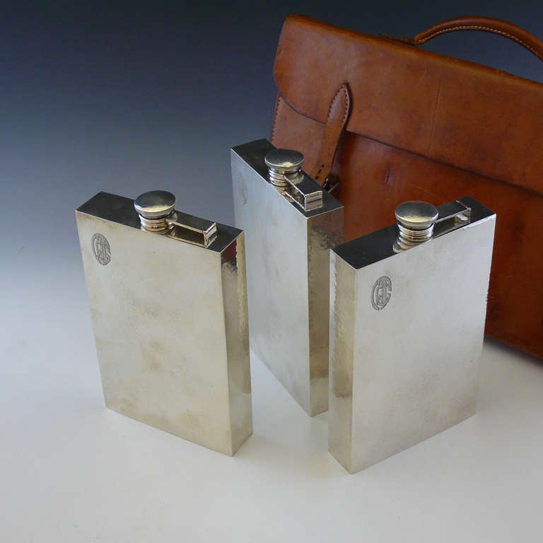American Amazing Leather Cased Set of Three Hammered Sterling Silver Flasks, circa 1925
