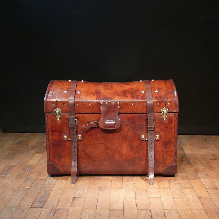 A stunning leather trunk with dome topped lid, originally designed to allow the rain to run off while on top of a carriage. Made by W. Andrews of Brighton, England.

Dimensions: 81.5 cm (length) x 51 cm (depth) x 61 cm (height)