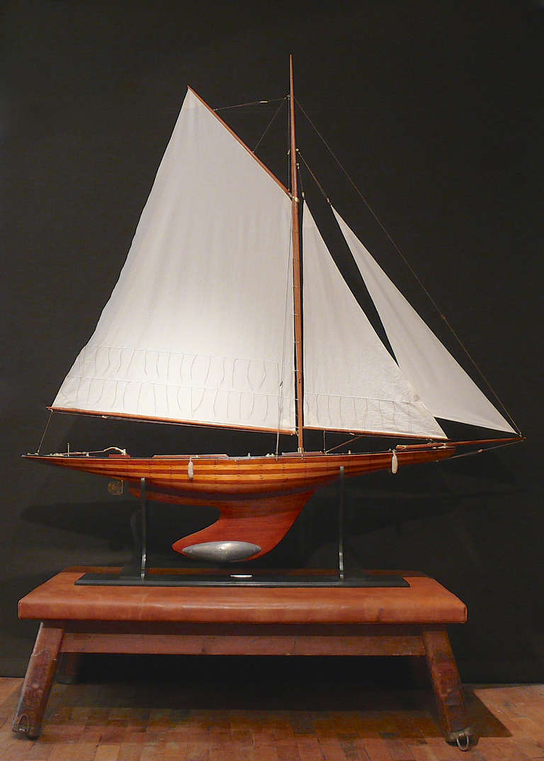 A wonderful large scale pond yacht with plank on frame hull and lead weighted keel; Circa 1910. Mounted on ebonised stand with engraved name plate 'Nyria'.

The original boat 'Nyria' was designed by C.E. Nicholson and was launched on the 10th