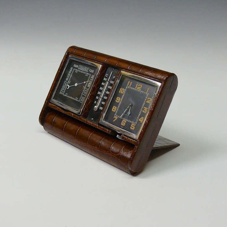 A sublime crocodile skin clock, barometer and thermometer made by Jaeger-Le Coultre, with simple but ingenious folding design for travel. Circa 1920.

Dimensions (open): 14.5 cm (width) x 11.5 cm (height)

Member of LAPADA.