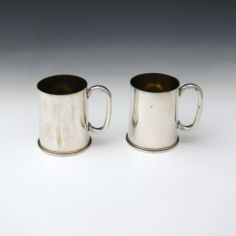 A wonderful pair of tankards made from brass WWI 18 pounder British artillery gun shells that have had a handle added and then been silver plated. Date stamps for 1915 and 1916.
