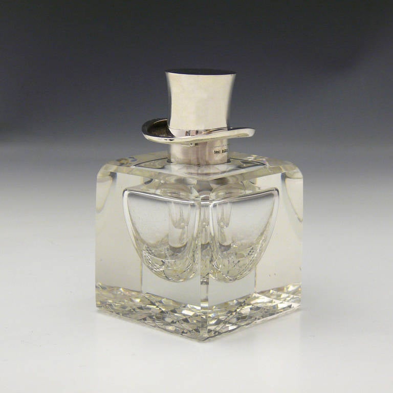 Exceptionally rare cut-glass and silver inkwell by J.C Vickery of Regent Street London. The top made in silver as a Top Hat, hallmarked London, 1912. 

Dimensions: 8.8 cm/3½ (width) x 8.8 cm/3½ inches (depth) x 14 cm/5½ inches (height).

Bentleys
