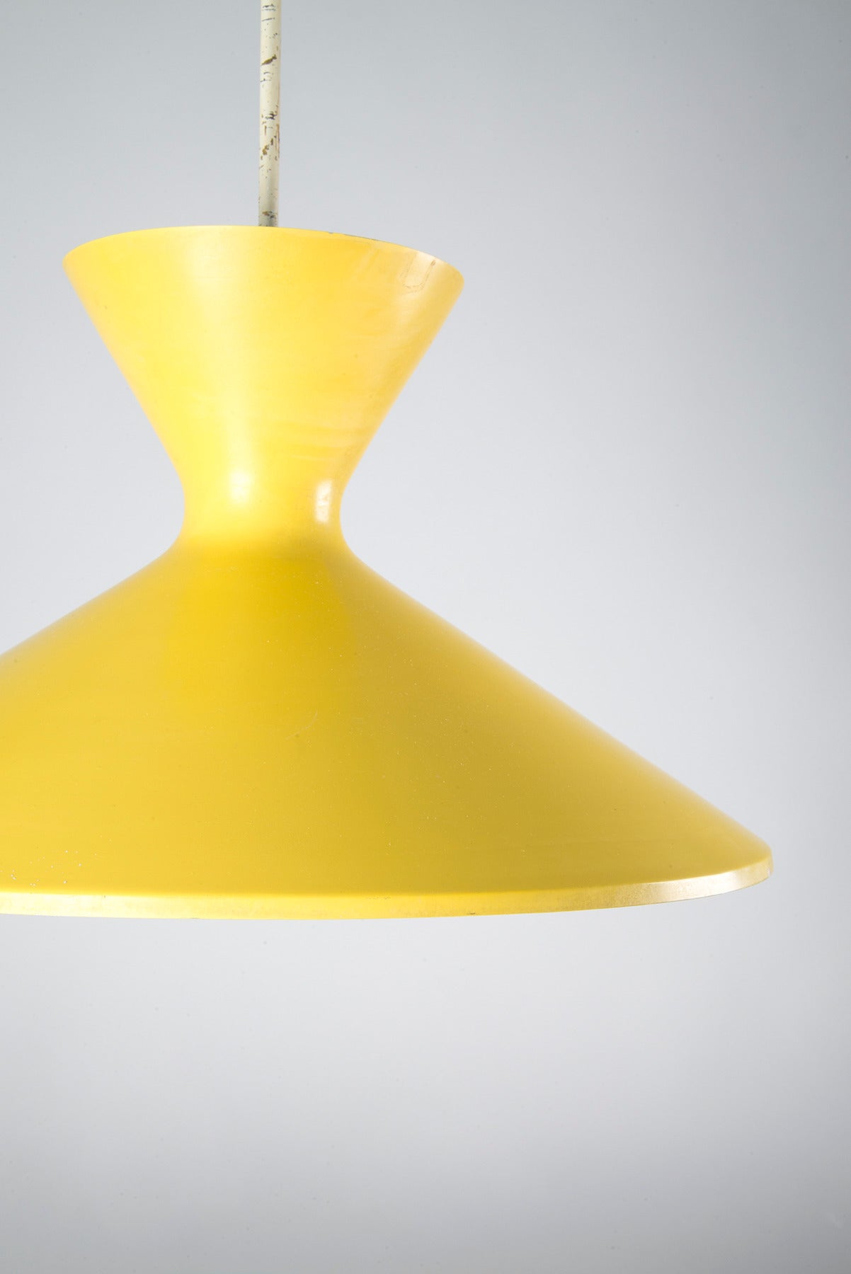 Pendant manufactured by O-Luce, Italy, in the 1950s. Yellow lacquered metal structure which spreads both downlight and uplight, white lacquered metal stem and cup.