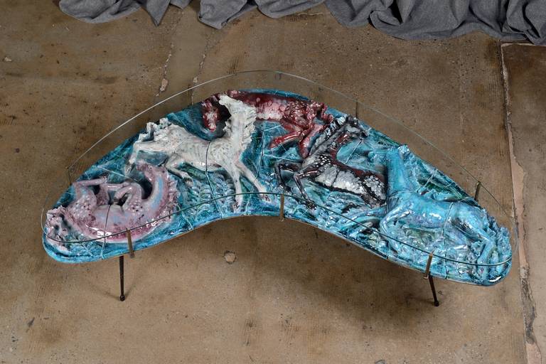 Extraordinary coffee table designed by artist Otello Rosa and manufactured by San Polo, Venice, in the 1950s. Enameled astonishing ceramic top, protected by a thick glass, depicting in relief horses, black lacquered metal legs and brass supports.