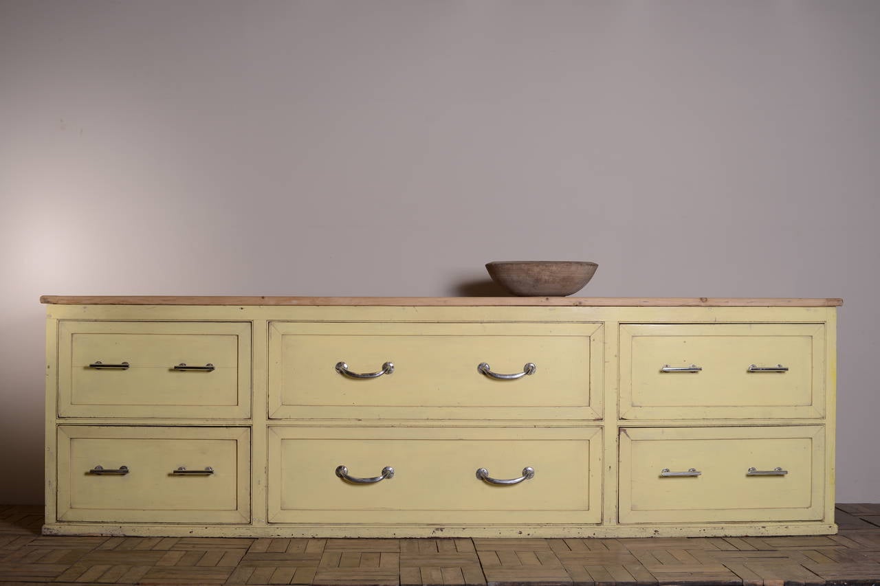 Large Edwardian Antique Outfitters Dresser Base.
This is an impressive English antique painted pine, six drawer dresser base originally used in a Gentlemen's outfitters store.
All six drawers are moulded and sport the original chrome pull