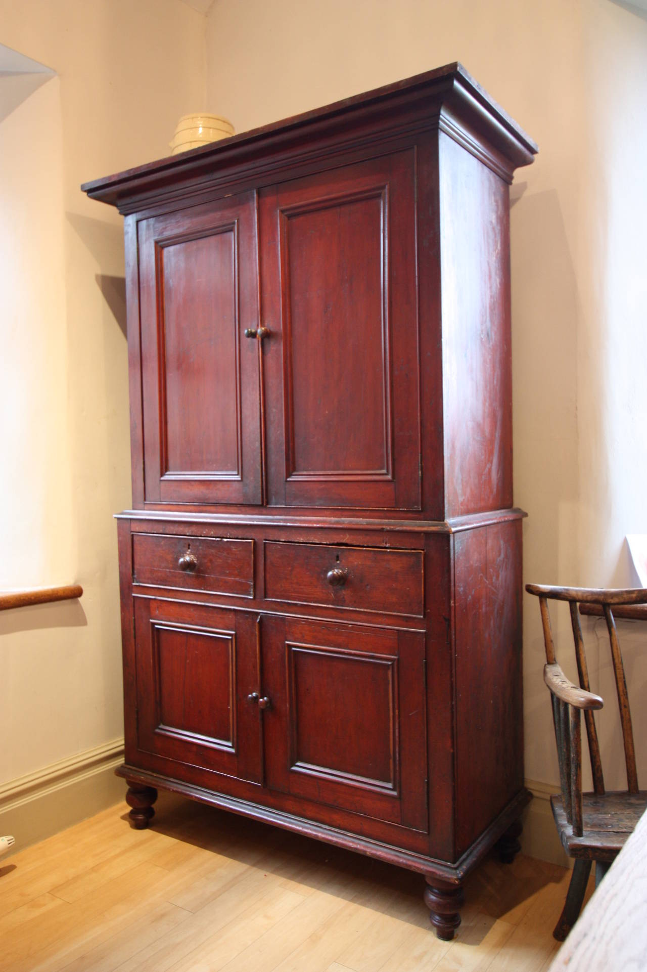 19th Century Antique Pine Food Cupboard.
This Welsh antique four door food cupboard slits at the waist and is in the original finish.
With a large out turned cornice to the top, then two cupboards doors over two more cupboards, this antique food