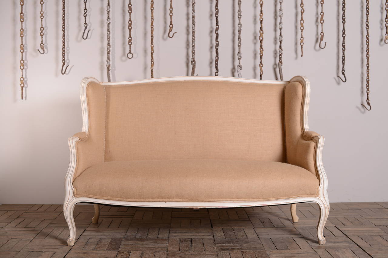 Fabulous Upholstered Antique Sofa in Original Paint.
This is a beautiful, shapely and curvy 19th century antique sofa that stands on four carved cabriole legs.
The sofa frame is in the original pale paint finish with faint gilt highlights.
A