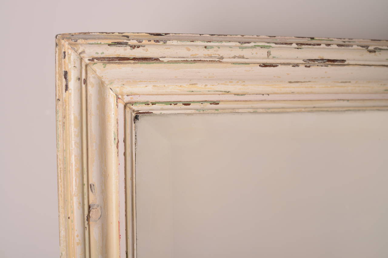 19th Century English Antique Mirror in Original Paint.
This English antique mirror has a lovely moulded pine frame which is in the original, worn paint finish.
The bevelled mirror plate is period and in very good condition.
This simple antique