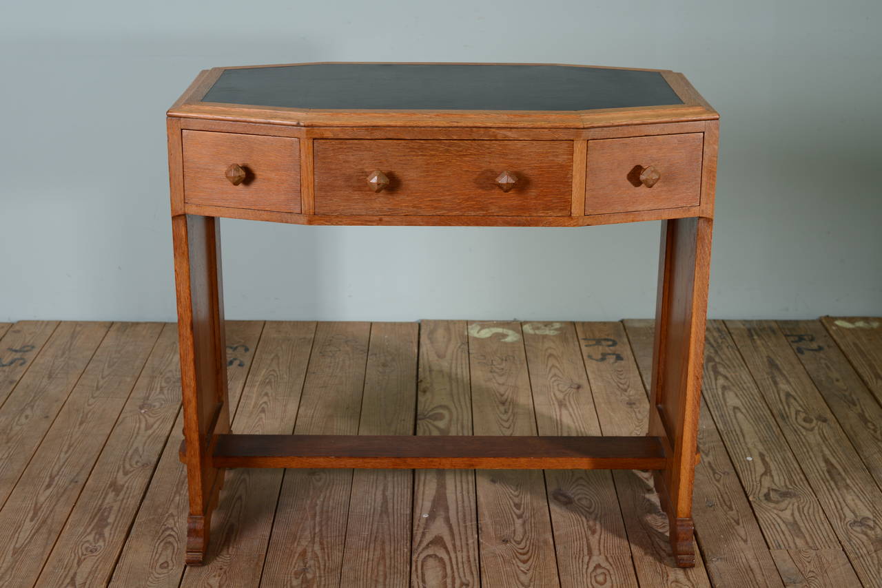 1930's Heals Oak Writing Table.
This is a beautiful quality, English solid oak writing / side table with an octagonal top, inset is a clean, black leatherette surface.
The three drawers along the front have lovely, wooden handles, all the drawer