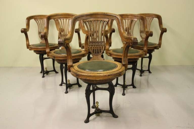 Set of Six Antique Oak Ships Dining Chairs.
An unusual set of late 19th century antique dinings chairs, originally made and used on a ship.
The oak dining seats are mounted on a cast iron revolving bases.
The black cast iron bases incorporate a