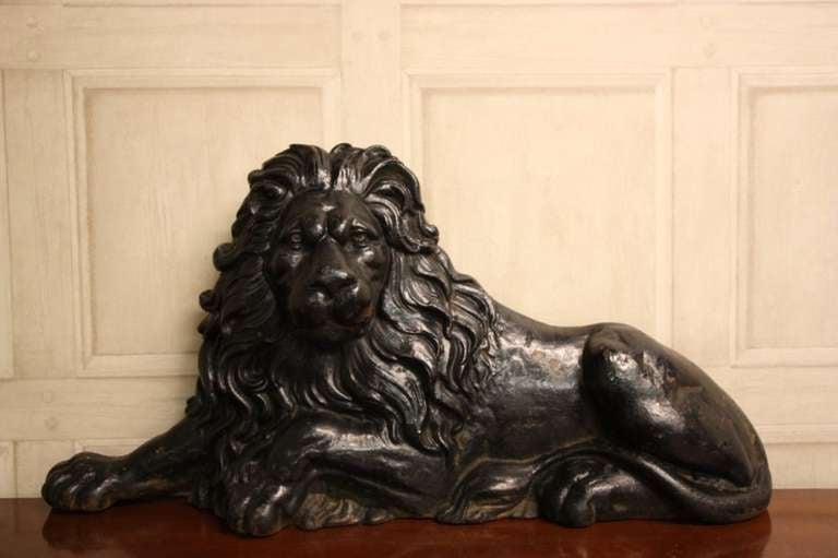 Handsome Antique Cast Iron Lion Door Stop.
This is a very finely cast, 19th century antique door stop in the form of a recumbent male lion.
In excellent condition and in its original back paint finish, this large and decorative antique lion door