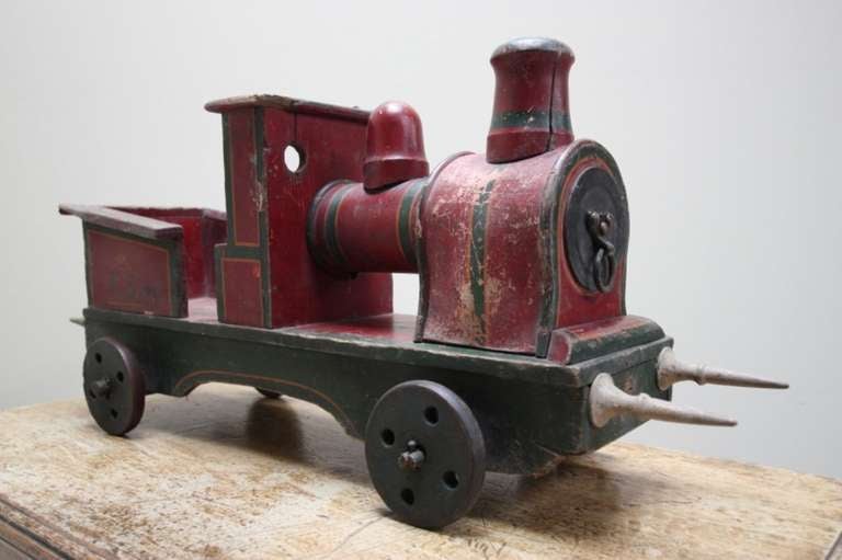 Edwardian English Antique Toy Train.
This is a super,large, early 20th century antique toy train made in solid wood and  in great, original condition.
All the paint work and hand painted decorations are totally original and untouched.
Choo, choo!