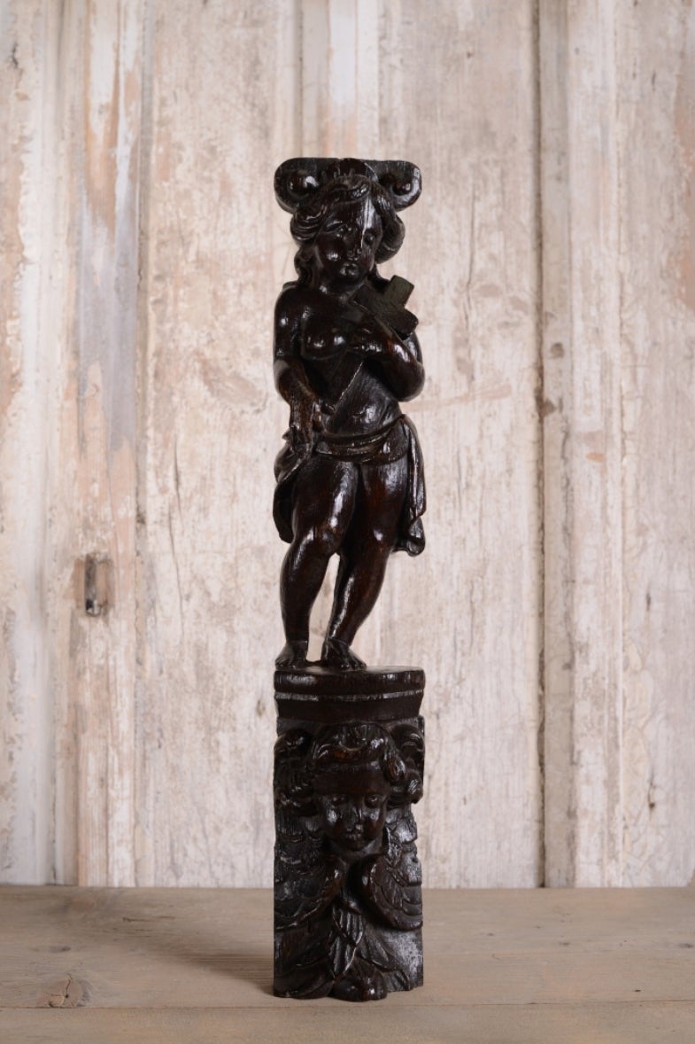 17th Century Carved Oak Naked Form.
A beautifully hand carved 17th century oak figure which holds a cross.
Supported by a cherub underneath, this Cromwellian antique oak figure is a fantastic colour and patina.
Carved from a single piece of oak,