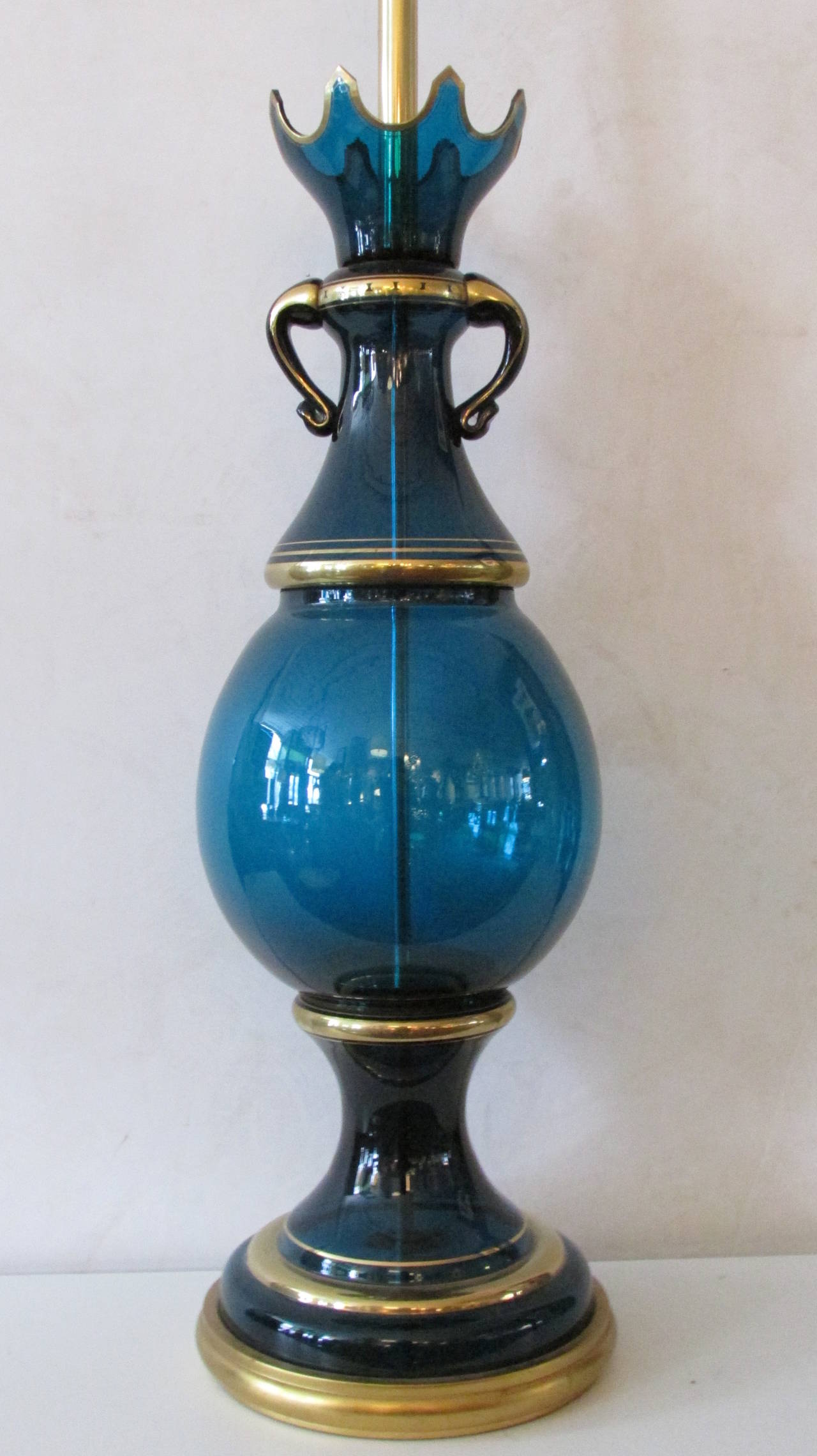 A spectacular large-scale Marbro lamp of brilliant rich teal blue and gilt decorated Italian Murano glass with shaped handles and crown design at top. Marbro Latmp Company, Los Angeles California foil labels. There is a website photo of a E. Stewart