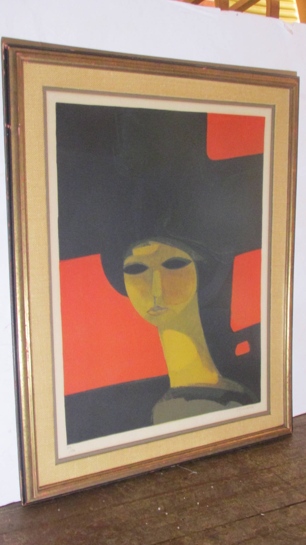 A beautiful lithograph of a woman in red by Andre Minaux (French 1923-1986) in the style of Modigliani, pencil signed and numbered by artist 34/150.