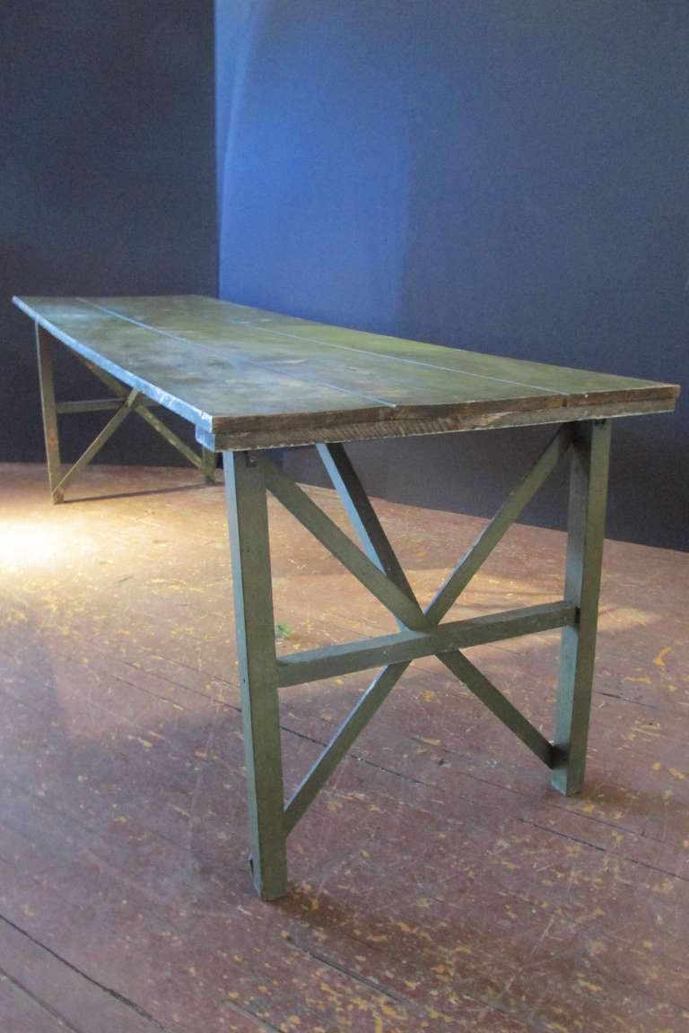 Antique American 8 1/2 foot long farm harvest table from an early ( now closed ) textile mill in New York State. Wide three board pine top and X stretcher base ends. It is in the original all over beautifully aged worn apple green painted surface.