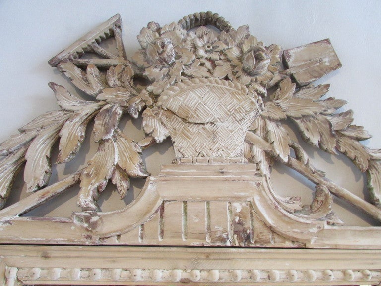 A carved bleached pine Louis XV style mirror - the top crest with urn / florals / rake & shovel - signed Palladio Made In Italy.