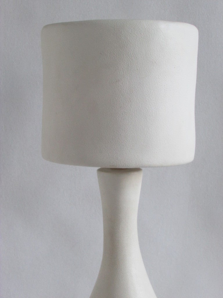 A modernist white lightly textured matt glazed ceramic table lamp in the style of Jean Michel-Frank / Georges Jouve. Incise monogram signed at base by electric cord. We think it is French - circa 1960 - 1970