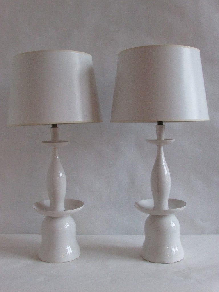 Exceptional pair of mid century modernist high glazed fine white porcelain pagoda form table lamps. Original milk glass inserts at top. We think these are Scandinavian / Danish in origin. The shades shown are for display purpose only.