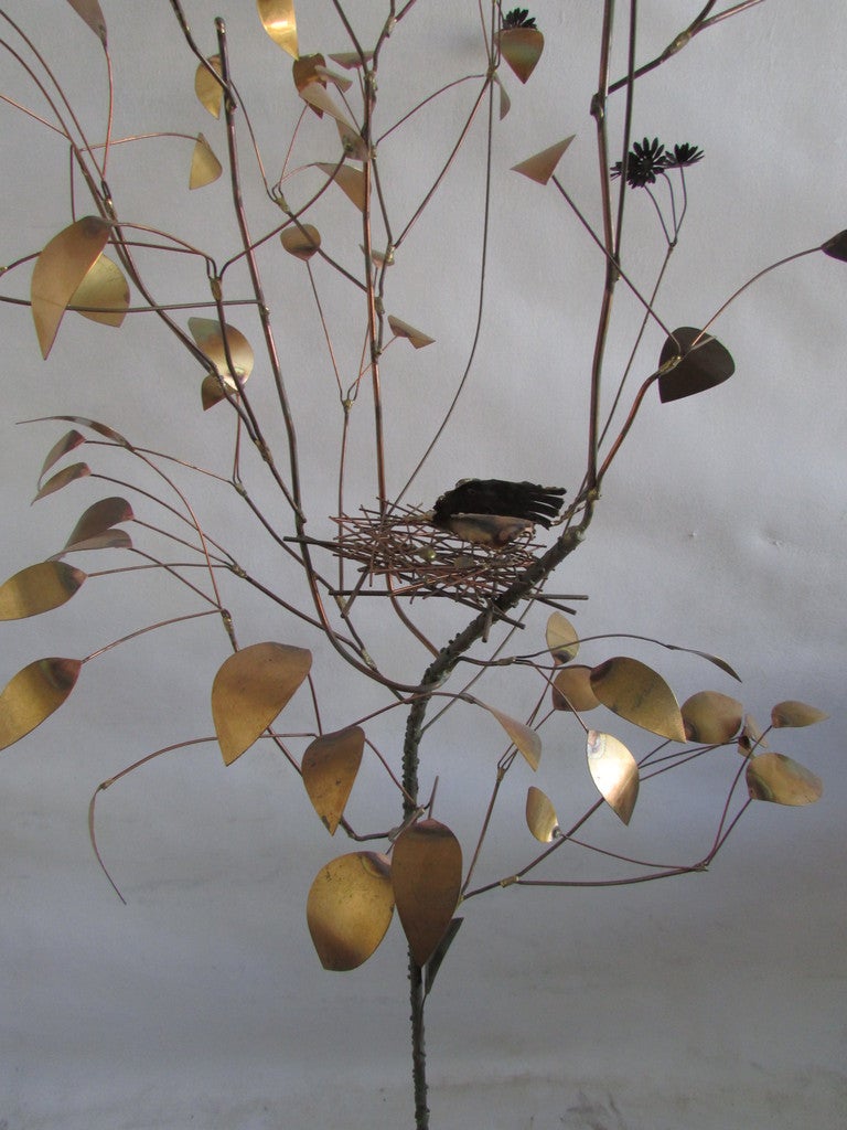 Large brass tree floor sculpture with bird and nest signed with trademark and C, Jere 1969 on metal plate that is mounted to original black painted wood base.
