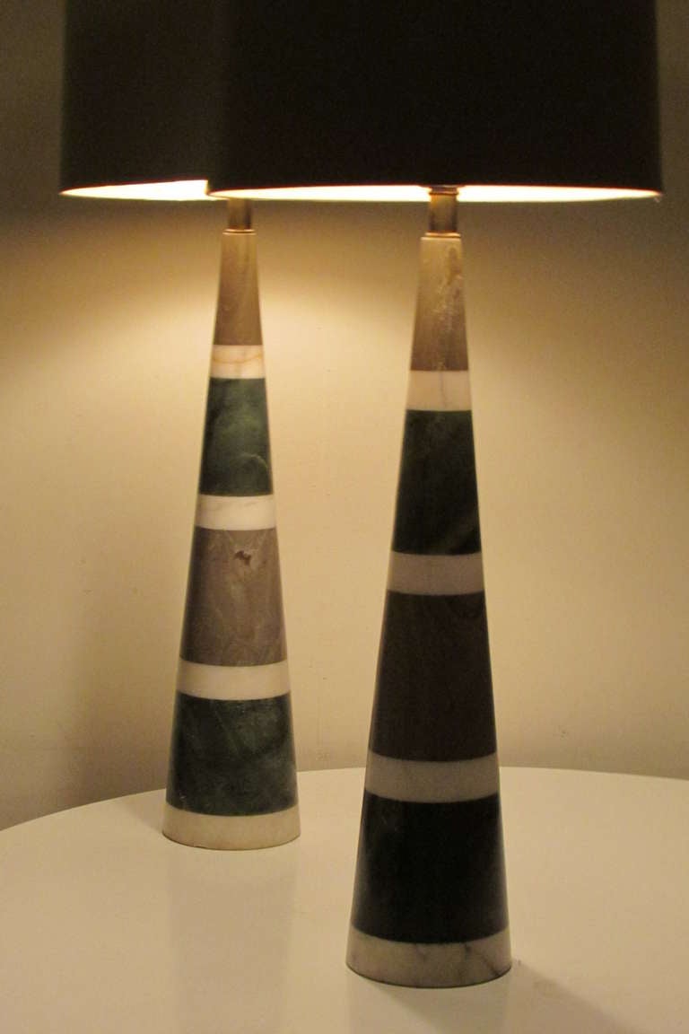 Pair of tapered cone shaped stacked polished marble & fossilized looking stone ( see gray colored segment of the stack ) table lamps with alternating colors of gray, white & green - all with beautifully aged veining. Each with the original green
