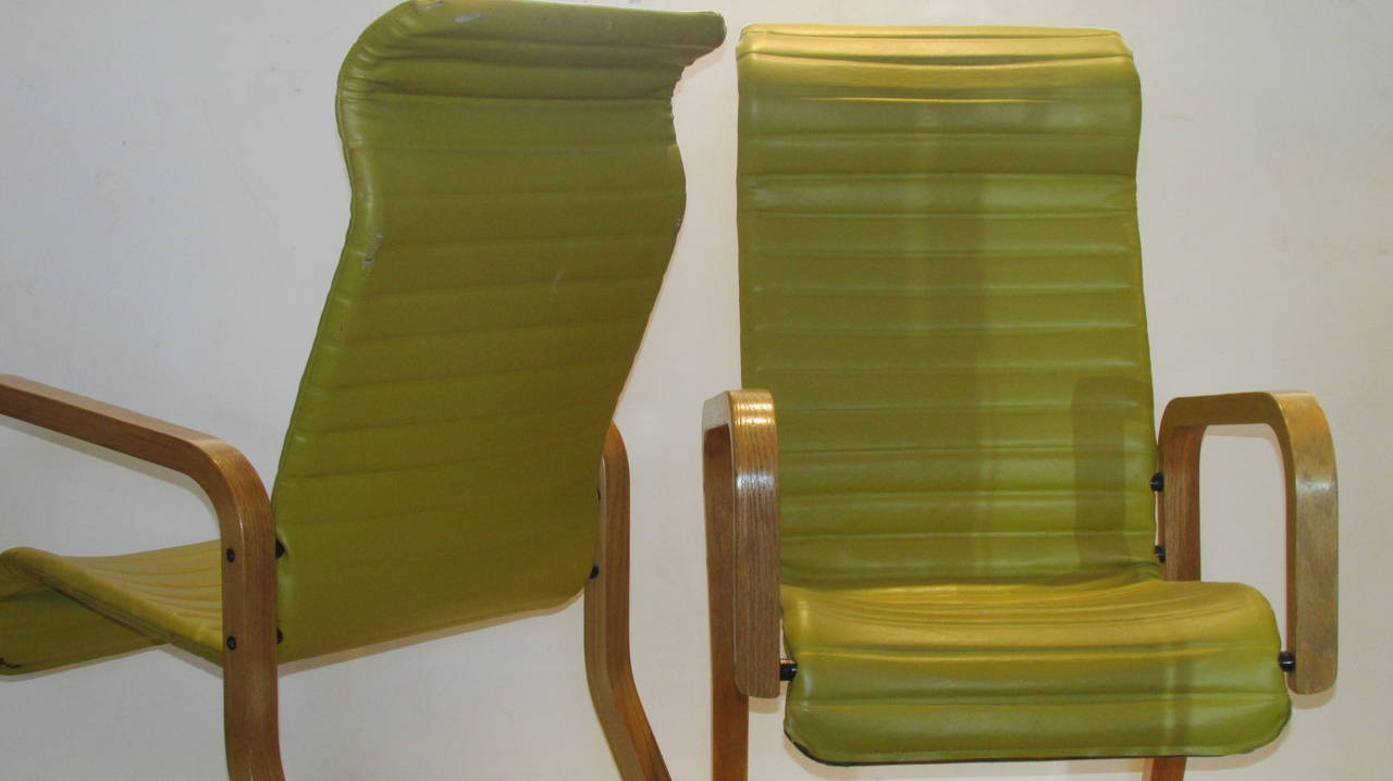 A pair of vintage signed Thonet large tall back bentwood cantilever grasshopper design armchairs in the original chartreuse ribbed vinyl upholstery. They are very comfortable and structurally strong.