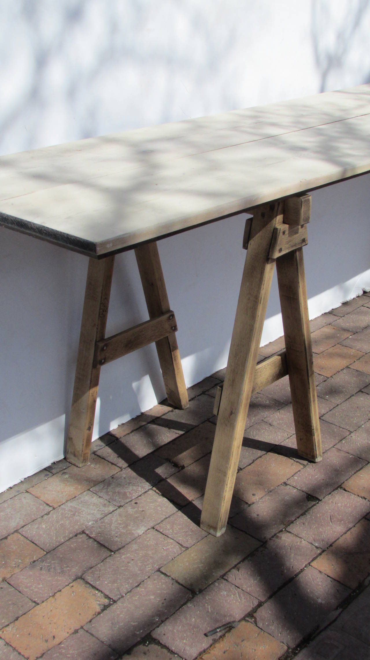 From Western New York State an all original 8 foot long wood sawhorse table with finely constructed hinged folding pine top in bleached limed finish. ( see picture number 9 for underside construction of wood top ).