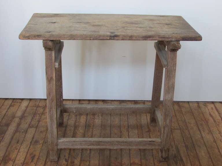 Antique Hispanic Mexican rustic utility work table. Splayed leg stretcher base with open mortised and pegged construction. Six large hand wrought round nail head rivets at single board top. Beautiful naturally aged pale color patina and wear to wood