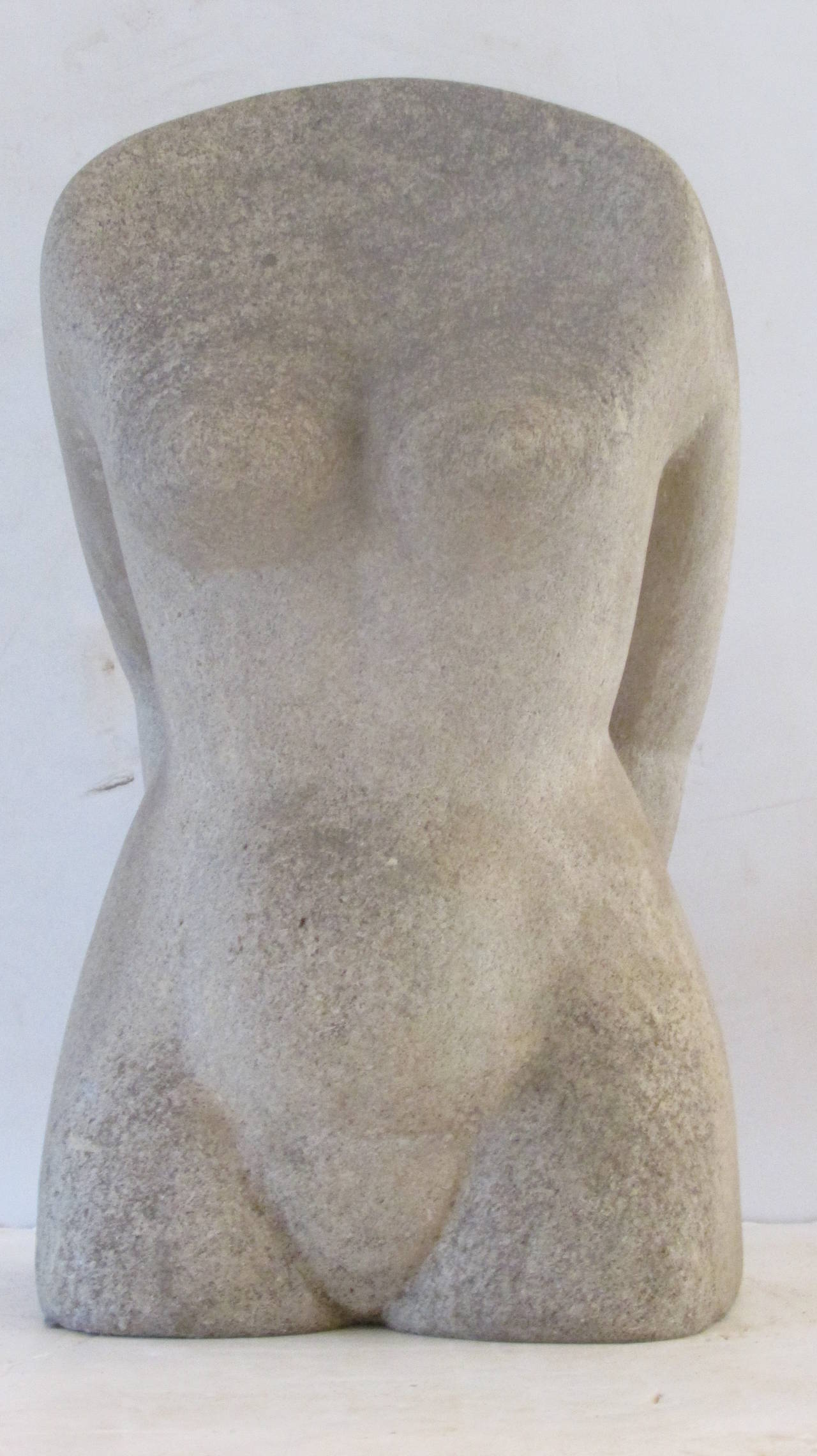 A carved stone female nude torso sculpture in a striking modernist pose that looks great from all angles. Beautiful aged surface color. Artist signed on underside but cannot make out. Found many years ago in Western NY State, circa 1940s.
