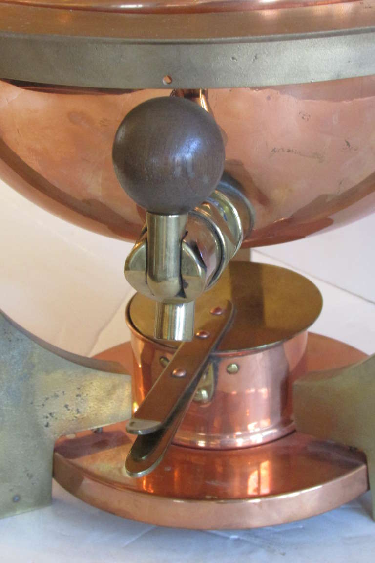 An exceptionally high quality heavy duty professional grade streamlined Art Deco copper & brass metal samovar with a modernist sculptural saturn ring form. This heats from a removable sterno burner at center of base. A period decorative accent piece