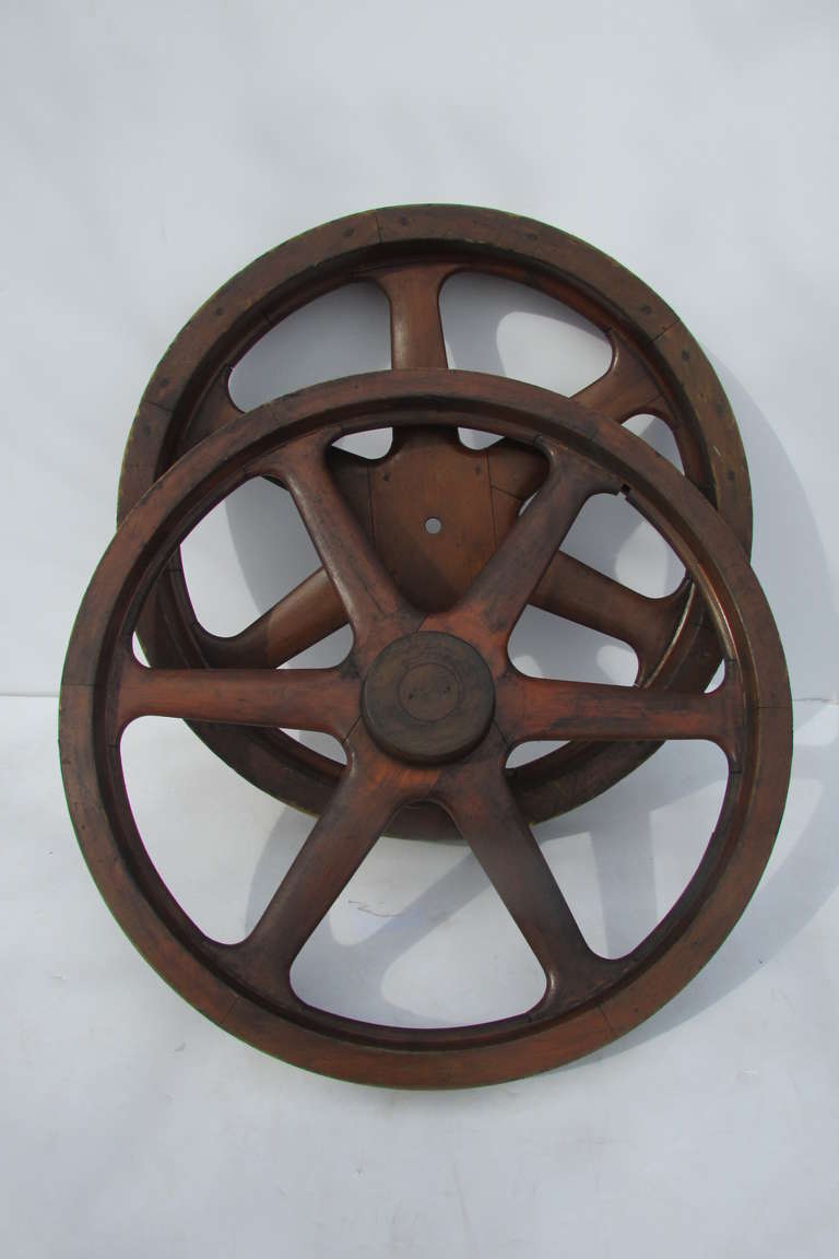A near pair of large antique wood foundry gear patterns with very fine quality construction, wood pegged joinery & original beautifully aged  color / patina to natural wood.  One having a metal tag, stenciling and a paper label with writing. The