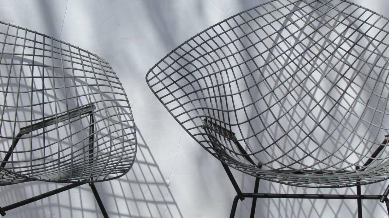 A nice pair of vintage Harry Bertoia diamond chairs for Knoll in the original black rilsan finish with some light wear at legs & a couple of very tiny wear spots on mesh - all welds are good and both chairs are structurally solid strong