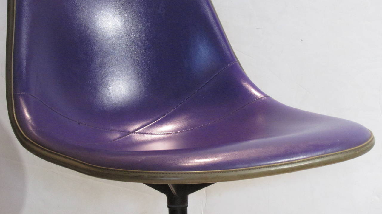 An Eames for Herman Miller swivel chair in the original & hard to find Alexander Girard brilliant royal purple stitched naugahyde  - signed / numbered / label present.