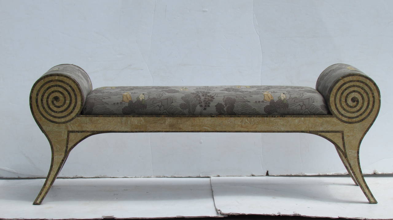 An exceptional and finely inlaid tessellated stone veneer curule form bench settee of parchment and brown bronze fossil stone with original muted gray brown green rusted orange scenic chinoiserie decorated fabric, attributed to Maitland-Smith, circa